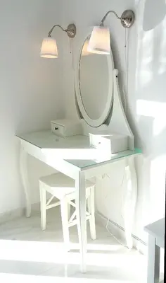 a white dressing table with a mirror and lights at Krezias Apartments E7 in Athens