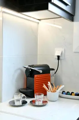 a toaster sitting on a counter with plates and glasses at Krezias Apartments E7 in Athens