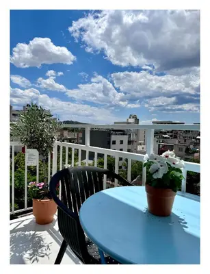 a blue table and two chairs on a balcony at Krezias Apartments E7 in Athens