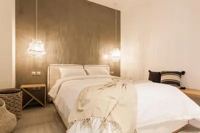 a bedroom with a large white bed with two lights at *** Apt 110m2 3bed 2bath, walk to Acropolis *** in Athens