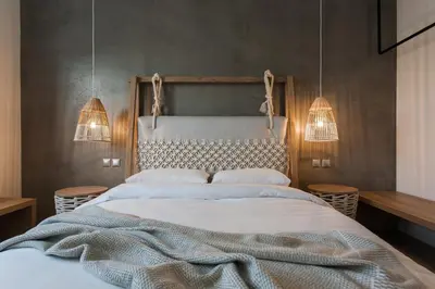 a bedroom with a large bed and two pendant lights at *** Apt 110m2 3bed 2bath, walk to Acropolis *** in Athens