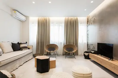 a living room with a couch and a tv at *** Apt 110m2 3bed 2bath, walk to Acropolis *** in Athens