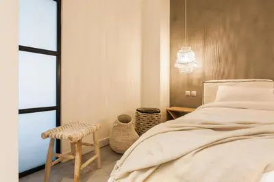 a bedroom with a bed and a stool next to a window at *** Apt 110m2 3bed 2bath, walk to Acropolis *** in Athens