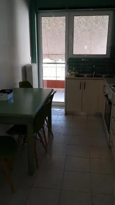 a kitchen with a table and chairs and a window at Athenian Luxury apartment, near metro station Chalandri, Nu 2 in Athens