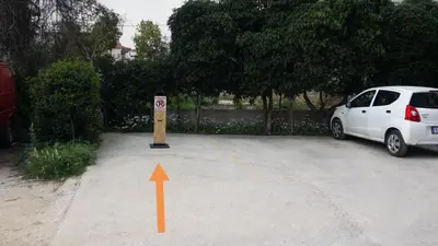 a white car parked in a parking lot with an orange arrow at Athenian Luxury apartment, near metro station Chalandri, Nu 2 in Athens