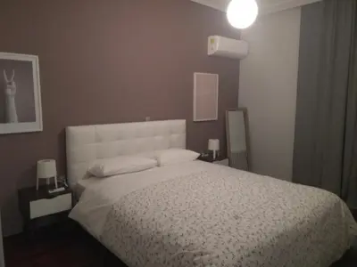 a bedroom with a large bed with a white bedspread at Athenian Luxury apartment, near metro station Chalandri, Nu 2 in Athens