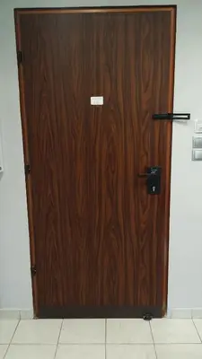 a large wooden door in a room with at Athenian Luxury apartment, near metro station Chalandri, Nu 2 in Athens