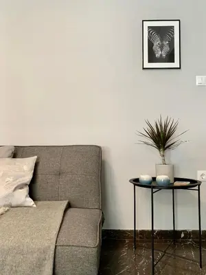 a living room with a couch and a table at Nadia's apartment , Athens in Athens