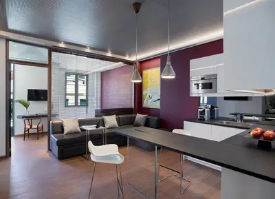 a kitchen and living room with a table and a couch at Athens Ikon in Athens