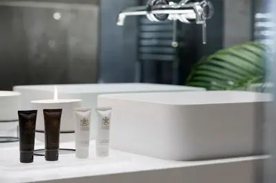 a bathroom with three tubes of hair products on a counter at Athens Ikon in Athens