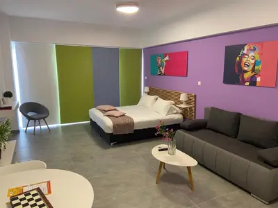 a living room with a bed and a couch at Connect Suites in Athens