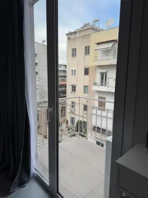 a window with a view of a building at Connect Suites in Athens