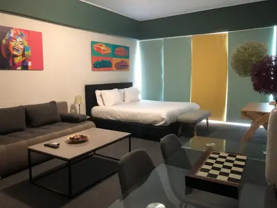 a room with a bed and a couch and a table at Connect Suites in Athens