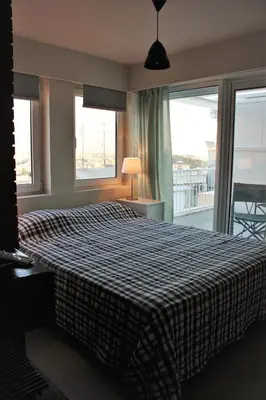 a bedroom with a large bed with a large window at Xenon Loft in Athens