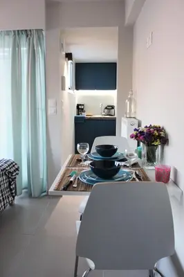 a kitchen with a table and chairs in a room at Xenon Loft in Athens