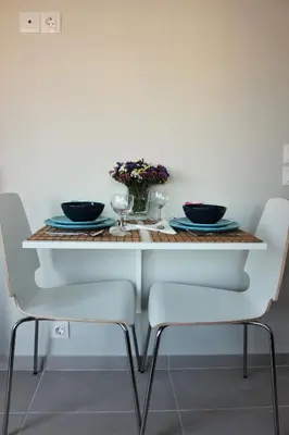 a white table with two black bowls and flowers on it at Xenon Loft in Athens