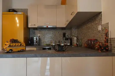 a kitchen with a yellow van on a counter at Georgina's cozy apartment -Metropolitan Hospital- in Piraeus