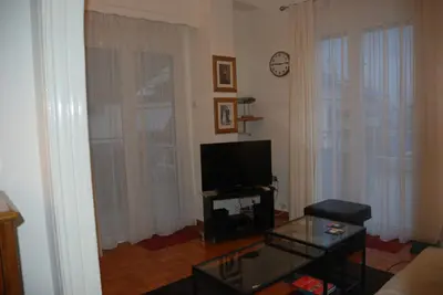 a living room with a tv and a coffee table at Soulis' penthouse near Acropolis in Athens