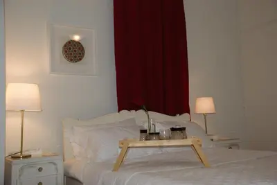 a bedroom with a bed with a table on it at Soulis' penthouse near Acropolis in Athens