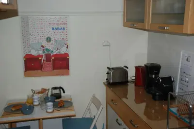 a kitchen with a counter and a table with a microwave at Soulis' penthouse near Acropolis in Athens