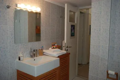 a bathroom with a sink and a mirror and a shower at Soulis' penthouse near Acropolis in Athens
