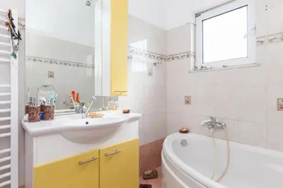 a bathroom with a tub and a sink and a bath tub at Country Rooms near Athens - Airport in Vravrona