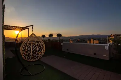 a lamp on a balcony with the sunset in the background at Athens Hawks in Athens