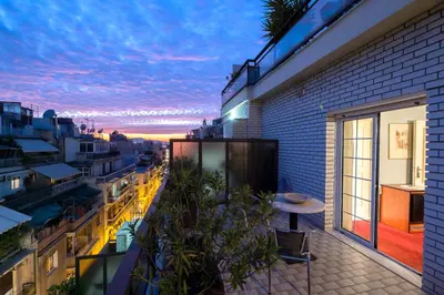 a balcony with a table and a view of the city at Victory Inn Hotel in Athens