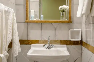 a bathroom with a sink and a mirror at Victory Inn Hotel in Athens