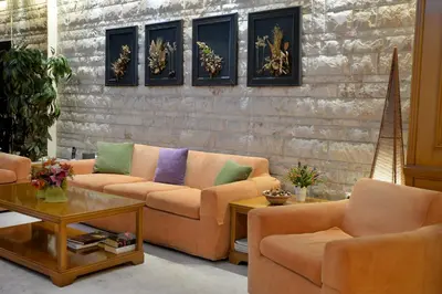 a living room with couches and a table at Victory Inn Hotel in Athens