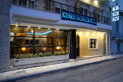 a store front of a hotel on a street at Victory Inn Hotel in Athens