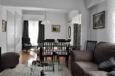 a living room with a couch and a table at Awesome Home 3' from Metro (M3) Station Agia Paraskevi in Athens