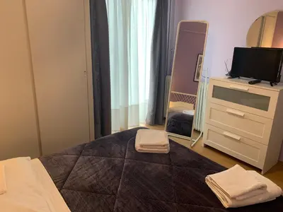 a bedroom with a bed and a dresser with a mirror at Awesome Home 3' from Metro (M3) Station Agia Paraskevi in Athens