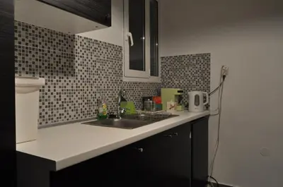 a kitchen counter with a sink and a microwave at Awesome Home 3' from Metro (M3) Station Agia Paraskevi in Athens