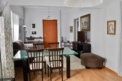 a dining room and living room with a table and chairs at Awesome Home 3' from Metro (M3) Station Agia Paraskevi in Athens