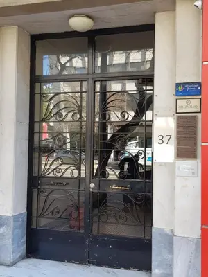 a glass door to a building with a car in it at ACROPOLIS MUSEUM APARTMENT in Athens