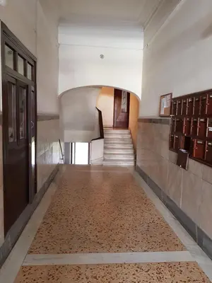 an empty hallway with a staircase and a door at ACROPOLIS MUSEUM APARTMENT in Athens