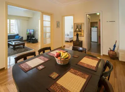 a dining room with a table with a bowl of fruit on it at ACROPOLIS MUSEUM APARTMENT in Athens