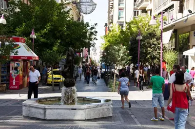 a fountain in the middle of a busy city street at ULTIMATE LOCATION CENTRAL ATHENS in Athens