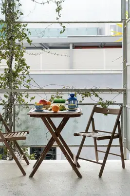 a table with a bowl of fruit and a chair at ULTIMATE LOCATION CENTRAL ATHENS in Athens