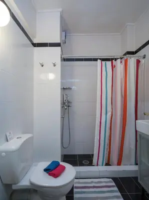 a bathroom with a shower curtain and a toilet at ULTIMATE LOCATION CENTRAL ATHENS in Athens