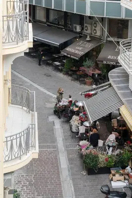 a street with tables and chairs in a building at ULTIMATE LOCATION CENTRAL ATHENS in Athens