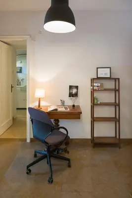 an office with a chair and a desk with a computer at ULTIMATE LOCATION CENTRAL ATHENS in Athens