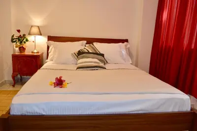 a bedroom with a large bed with a red curtain at Perfect View in Piraeus