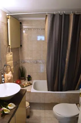 a bathroom with a tub and a toilet and a sink at Perfect View in Piraeus