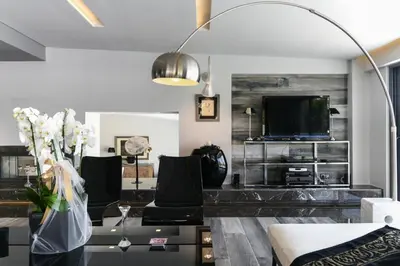 a living room with a couch and a tv at Luxury Beachfront Villa Selenia Platinum in Sounio in Sounio