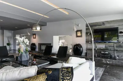 a living room with a white couch and a table at Luxury Beachfront Villa Selenia Platinum in Sounio in Sounio