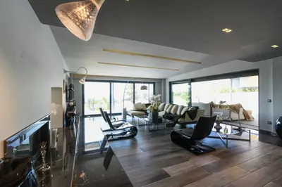 a living room with a couch and chairs and a television at Luxury Beachfront Villa Selenia Platinum in Sounio in Sounio