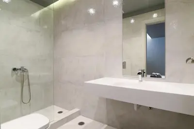 a bathroom with a sink and a toilet and a mirror at Luxury Beachfront Villa Selenia Platinum in Sounio in Sounio