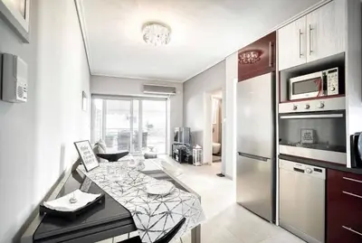 a kitchen with a table and a refrigerator at Elea Athens Apartment in Athens